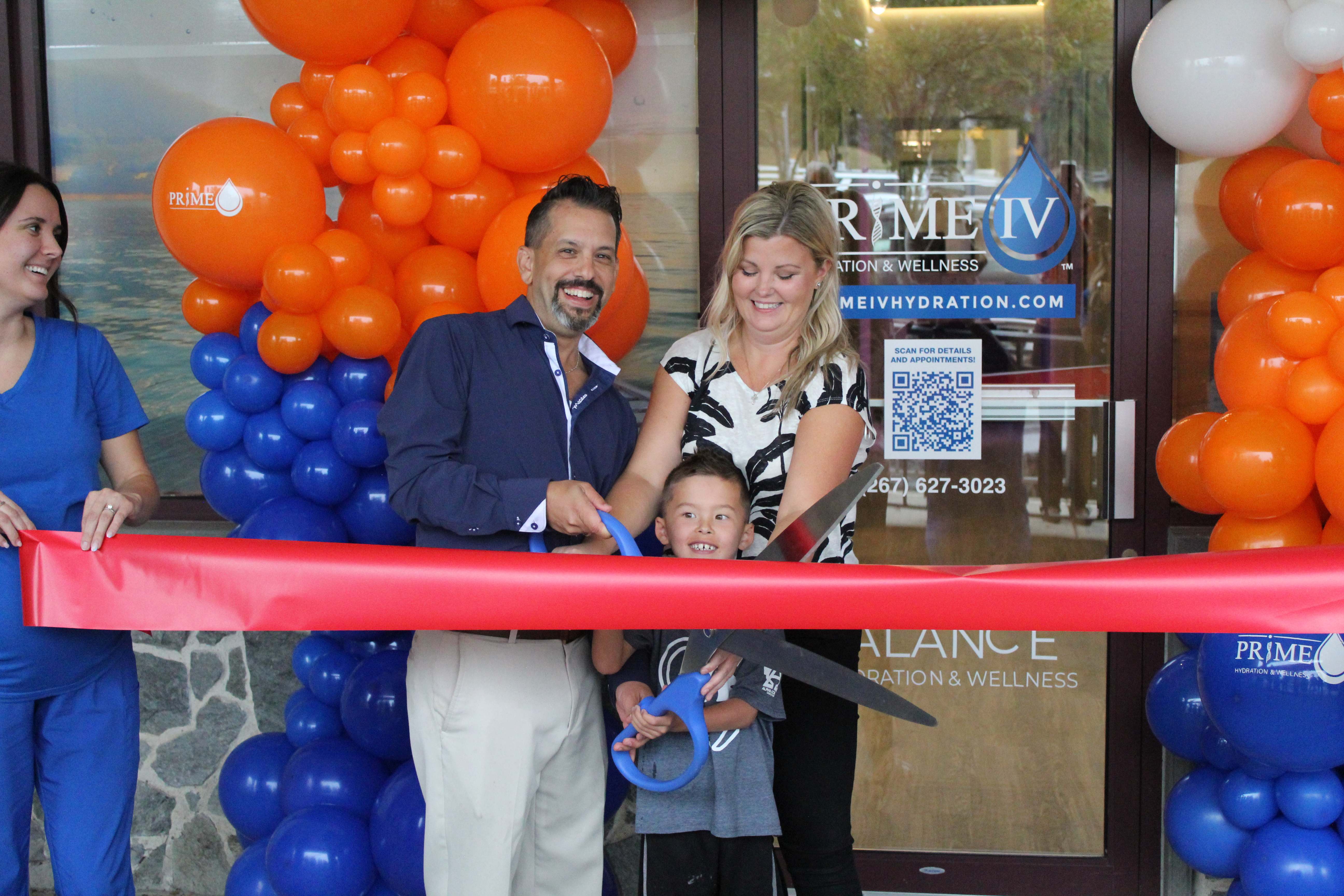 Peter and Jenny Kyriakodis with their son at the Prime IV Blue Bell ribbon cutting ceremony